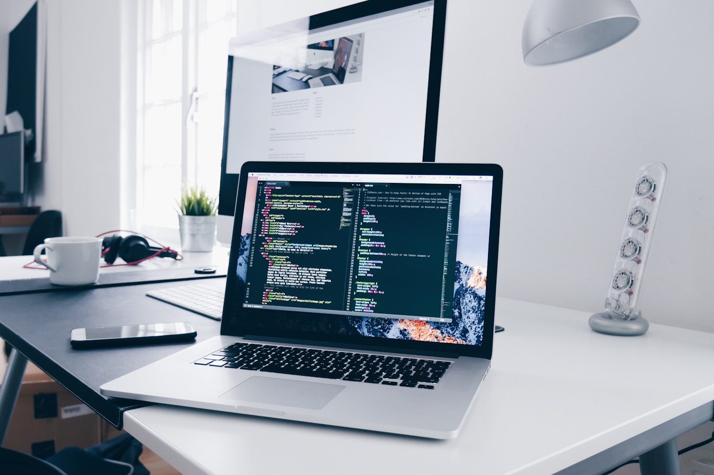 Apples Unique Designs Designer working at laptop in warm workspace